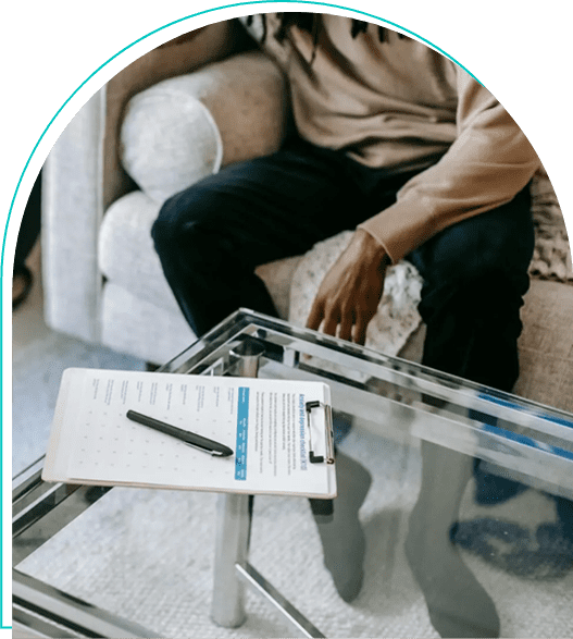 A man sitting on top of a glass table.